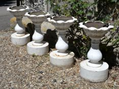 A set of four cast iron garden urns, in the manner of examples by Andrew Handyside and co. of Derby,