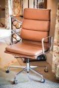 A tan leather and chromed metal desk chair, with label for Charles Eames, AUTHORISED ORIGINAL,