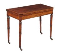 ϒ A Regency mahogany and ebony inlaid card table, circa 1815, on ring turned legs