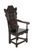 A carved oak Wainscot chair in Tudor style, late 19th century, the backrest bearing inscription W