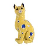 A fayence model of a cat attributed to Emile Gallé, painted with blue spots and shaped panels