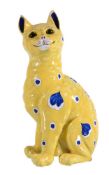 A fayence model of a cat attributed to Emile Gallé, painted with blue spots and shaped panels