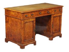 A Victorian burr walnut pedestal desk, late 19th century, stamped Heal & Sons, London to one drawer,