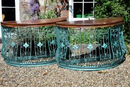 A pair of painted wrought iron balcony guards, circa 1900, of demi-lune form, later reconditioned