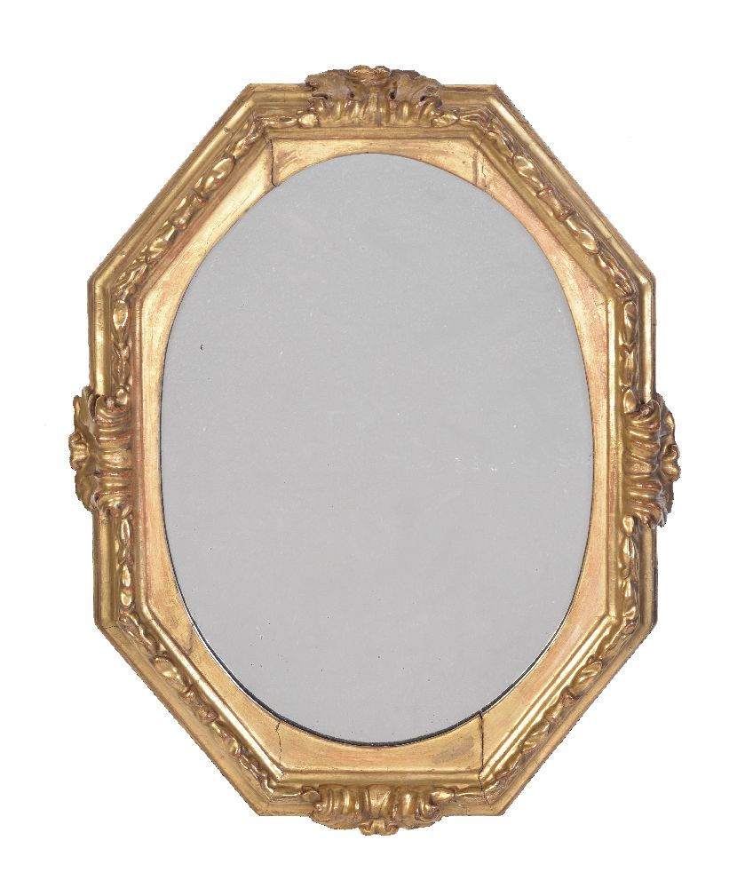 An Italian giltwood mirror, 17th century, of octagonal form, with four prominent acanthus leaves and