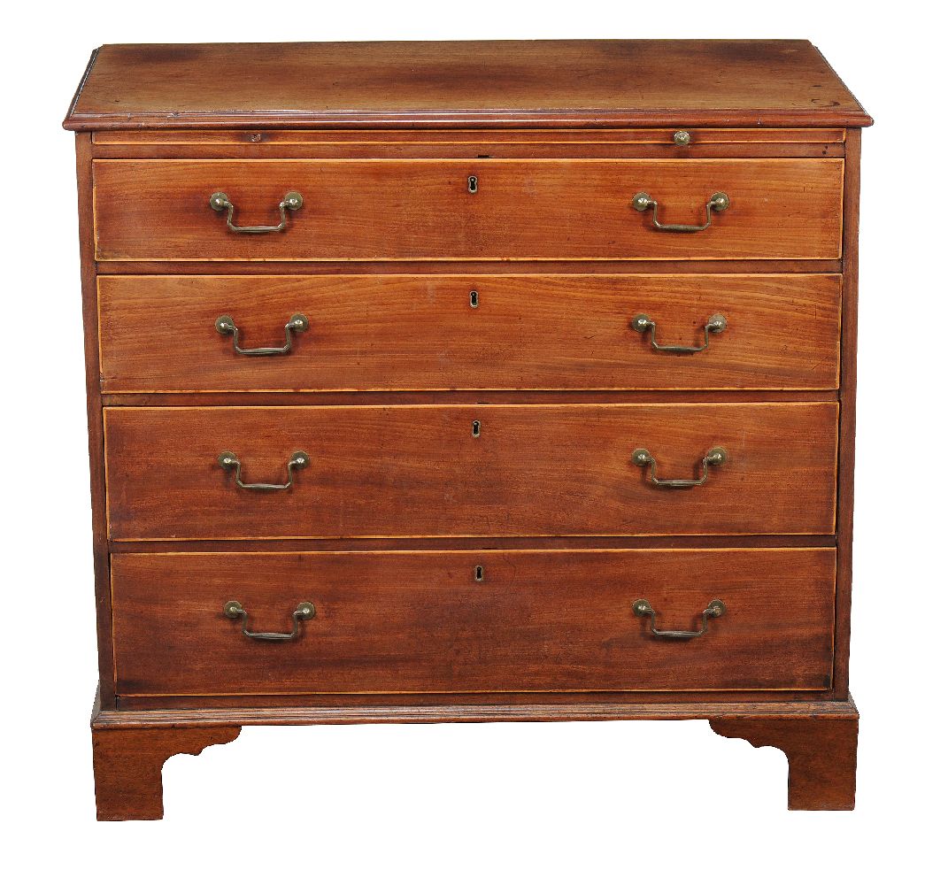 A George III mahogany and line inlaid chest of drawers, early 19th century, with brushing, slide,