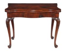 A George III mahogany card table, circa 1780, the serpentine shaped top opening to a tooled