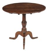 A George II oak tripod table, mid-18th century, 69cm high, 80cm diameter