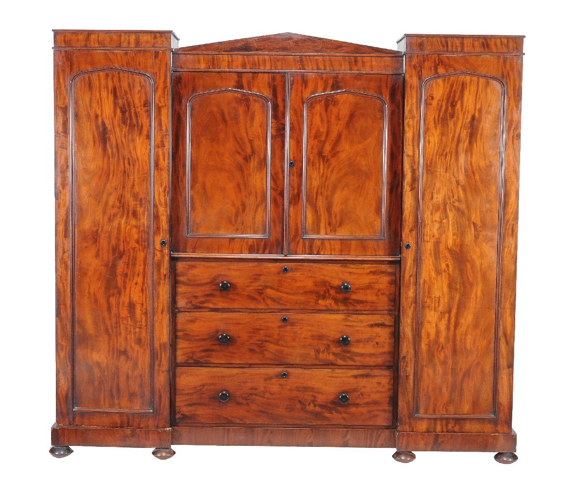 An early Victorian mahogany compactum wardrobe, circa 1850, the central section with cupboards