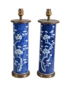 A Pair of Chinese blue and white gilt-metal mounted 'Prunus' vases, adapted as lamps, 31cm high