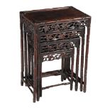 A Chinese carved and pierced hardwood nest of four tables, the largest 73cm high, 51cm wide, 36cm