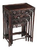 A Chinese carved and pierced hardwood nest of four tables, the largest 73cm high, 51cm wide, 36cm