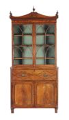 A Regency mahogany and inlaid secretaire, circa 1815, the secretaire drawer fitted with an