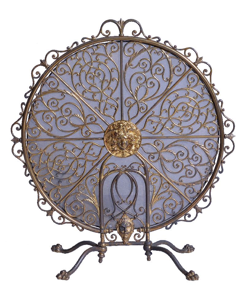 A gilt brass and mesh panel firescreen, late 19th/ early 20th century, the pierced scrollwork design