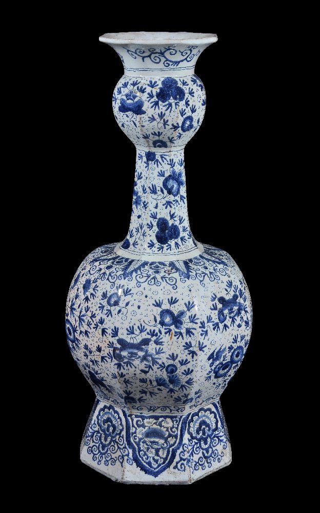 A Dutch Delft blue and white garlic neck octagonal section vase, late 19th century, decorated with a