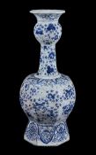 A Dutch Delft blue and white garlic neck octagonal section vase, late 19th century, decorated with a