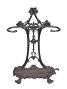 A Victorian cast iron walking stick stand, with openwork foliate cast backplate and scrolled