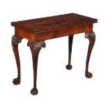 A George II mahogany card table, circa 1740, possibly Irish, the folding top opening to baize