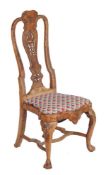 A George II carved walnut chair, circa 1730, after the manner of Daniel Marot, with drop in seat,