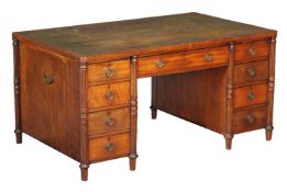 A mahogany desk in Regency style, 19th century, the green leather inset top above a frieze drawer