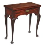 A George II mahogany tea table, circa 1740, the folding top above single frieze drawer and slender