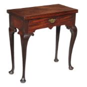 A George II mahogany tea table, circa 1740, the folding top above single frieze drawer and slender