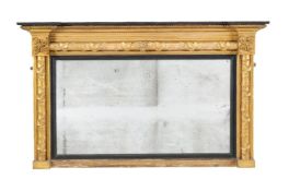 A Regency giltwood and composition wall mirror, circa 1815, the rectangular plate within an ebonised