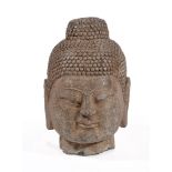 A Chinese stone head of a Buddha, the hair and topknot carved with tight curls, 31cm high