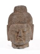A Chinese stone head of a Buddha, the hair and topknot carved with tight curls, 31cm high