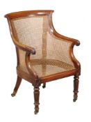 A George IV mahogany library armchair, circa 1825, attributed to Gillows, with caned back, arms, and