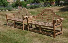 A pair of teak garden benches in the manner of designs by Lutyens, of recent manufacture, the arched