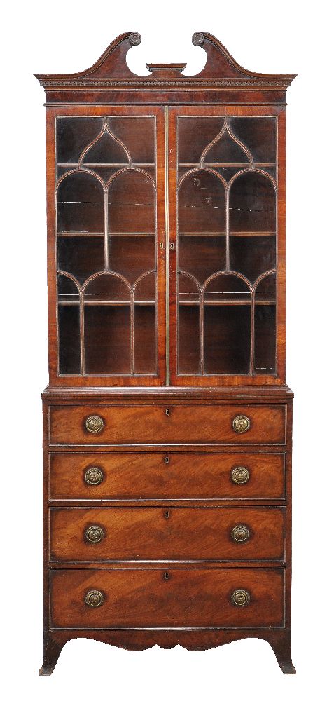A George III mahogany bookcase, circa 1800, the astragal bookcase above a chest of four drawers,