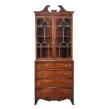 A George III mahogany bookcase, circa 1800, the astragal bookcase above a chest of four drawers,