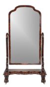 An early-Victorian flame mahogany cheval mirror, circa 1850, with scrolled supports and shaped