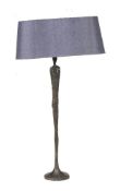 A bronzed table lamp in the form of a stylised standing figure, modern, 65cm high excluding