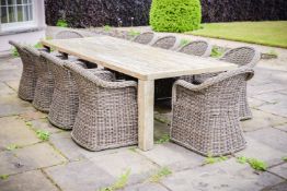 A teak garden table and ten faux wicker chairs, retailed by GLOSTER, of recent manufacture, table of