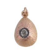 A Soviet diamond set egg pendant, post 1958, the gold coloured egg with two types of engraved