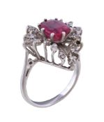 A pink doublet stone and diamond ring, the oval cut pink doublet stone, claw set within a surround