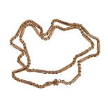 A 1960s reproduction gold coloured long chain, the fancy belcher link chain with cast foliate scroll