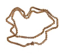 A 1960s reproduction gold coloured long chain, the fancy belcher link chain with cast foliate scroll