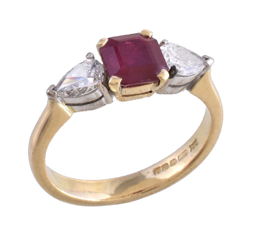 An 18 carat gold ruby and diamond ring, the central square cut ruby claw set between pear cut