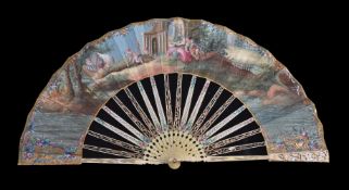 ϒ An ivory fan, late 18th century, the guards pierced and carved with mother of pearl backing, the
