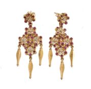 A pair of enamel, ruby and diamond flower head earrings, the white enamel flower head panels set