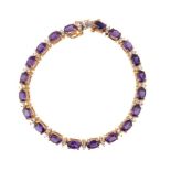 An amethyst and diamond bracelet, set with alternating oval cut amethysts and duos of brilliant