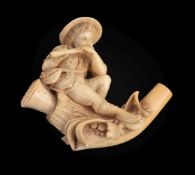 A meerschaum cheroot pipe, circa 1900, carved with a country boy playing a musical pipe, the