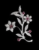 A 1960s 18 carat gold diamond and ruby floral spray brooch, the floral spray set with eight cut