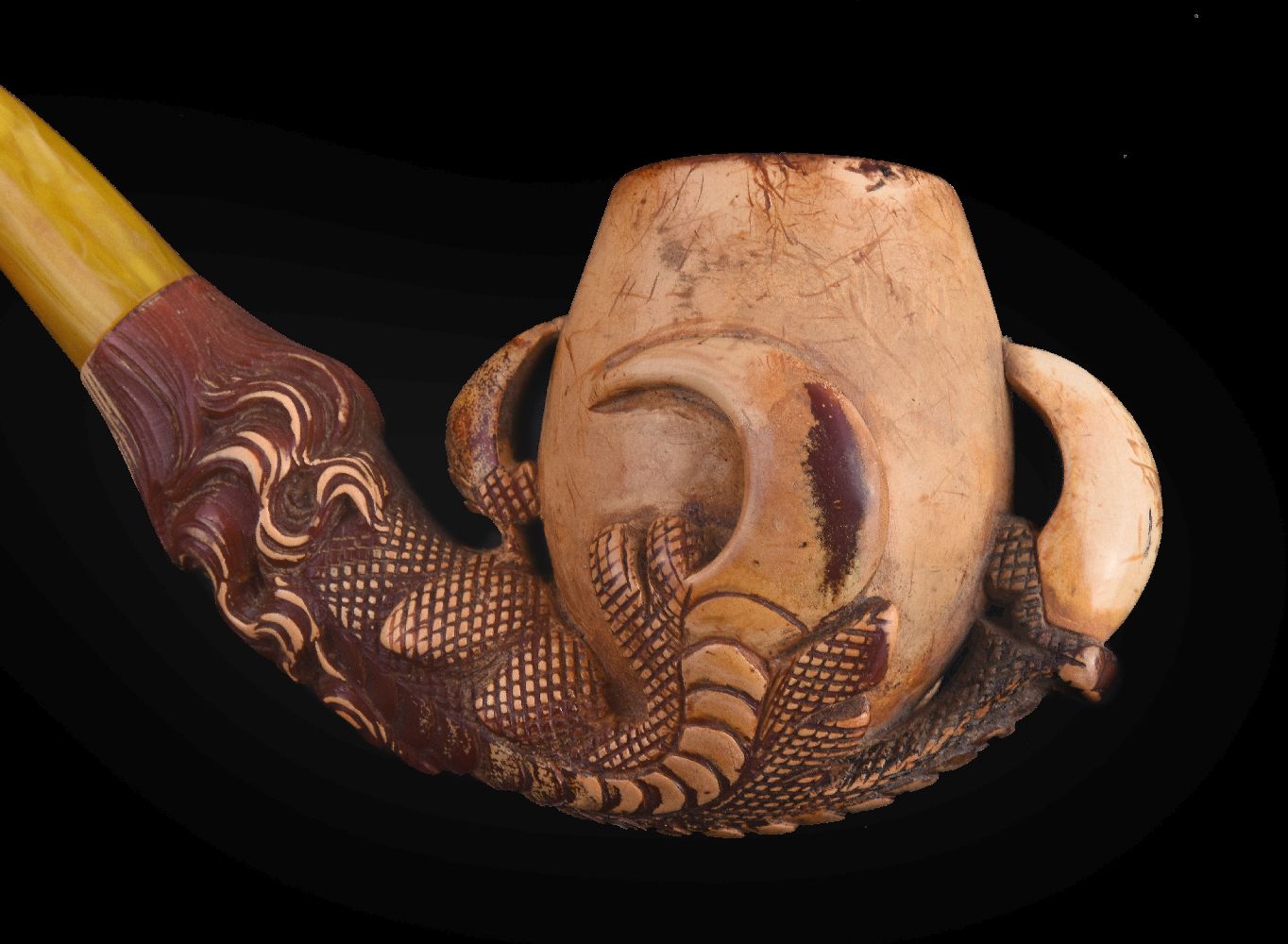 A meerschaum pipe, early 20th century, carved as an eagle's talon holding an egg, with an amber - Image 3 of 3