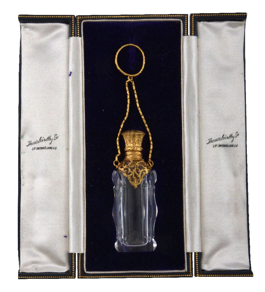 A gilt metal mounted cut glass scent bottle, late 19th century, scroll foliate engraved and pierced,