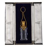 A gilt metal mounted cut glass scent bottle, late 19th century, scroll foliate engraved and pierced,