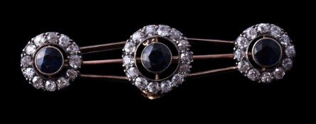 An early 20th century sapphire and diamond brooch, circa 1900, the three clusters each set with a